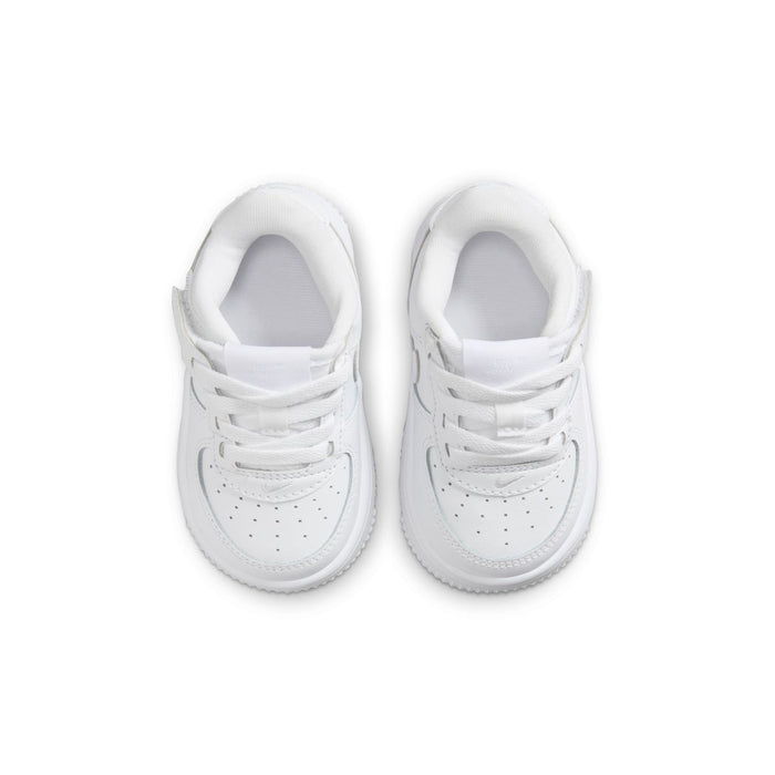 Toddler white low-top sneakers, front view with lace-up eyelets and perforated toe