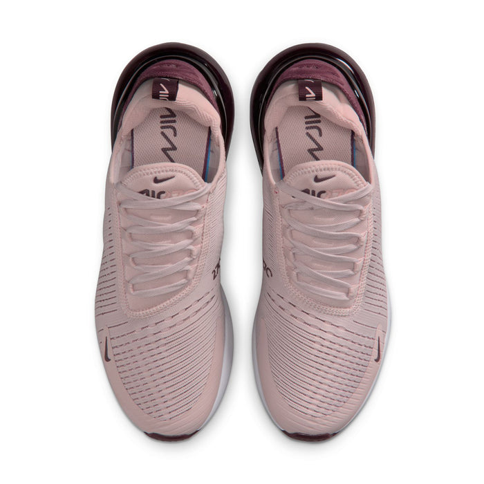 Dusty pink lace-up running shoes with Nike Swoosh and breathable knit texture on top