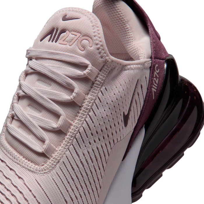 Close-up of dusty pink knit upper with laces, burgundy logo, and black air sidewall