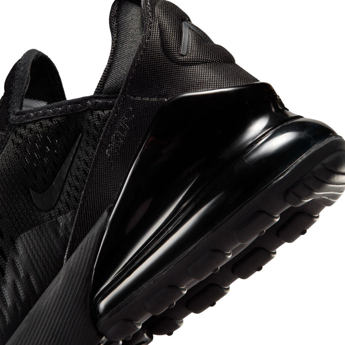 Youth black sneaker side close-up of air unit edge and textured mesh panel