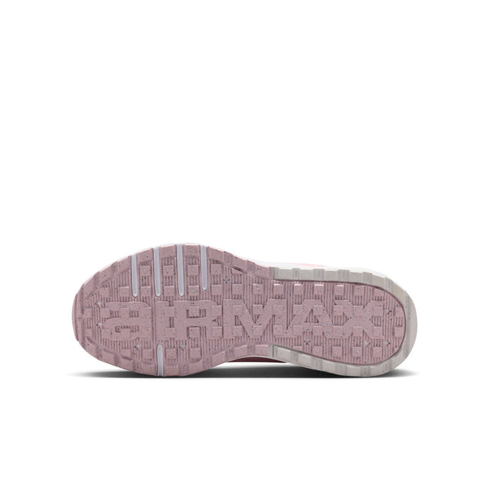 Sole of pink youth running sneaker with textured tread and light gray details
