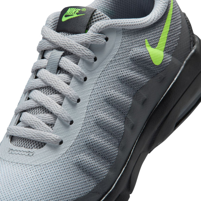 Close-up of kids' grey knit upper with white laces, neon green Swoosh, and Nike logo
