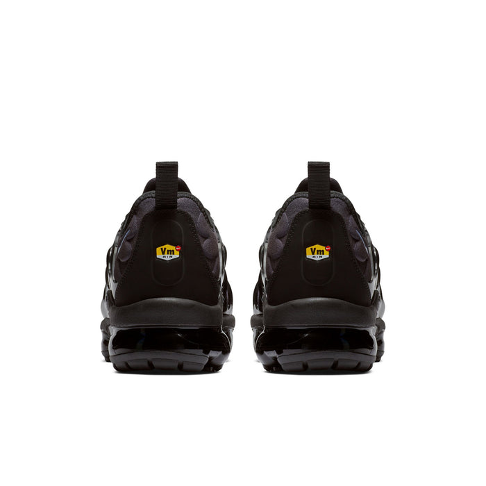 Back view of sneakers with black heel panels, Vm logo tab, and Air sole