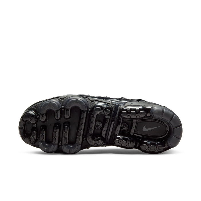 Men's black outsole view with tread pods and Air cushioning chambers