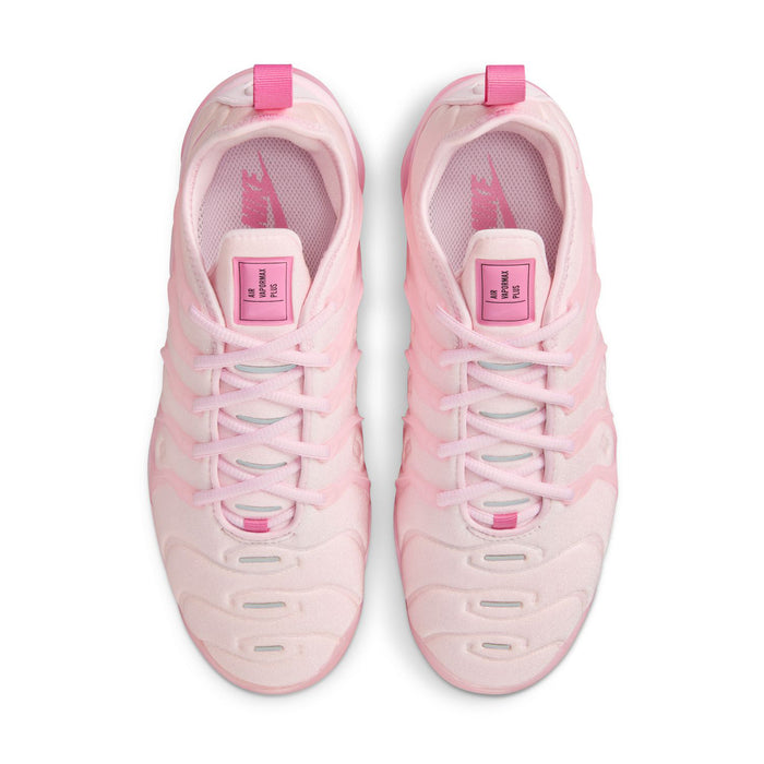Pink women's sneakers viewed from above, showing lace-up closure and cushioned tongue
