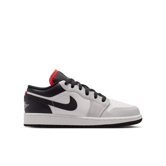 Youth low-top sneakers, white and black with red heel accents and Nike swoosh