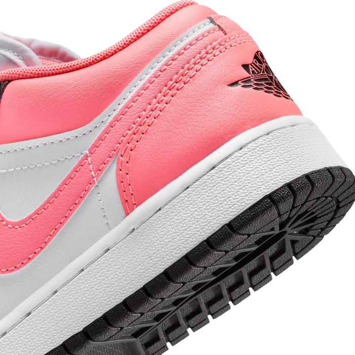Close-up of youth sneaker side with pink leather, white midsole, and black outsole tread