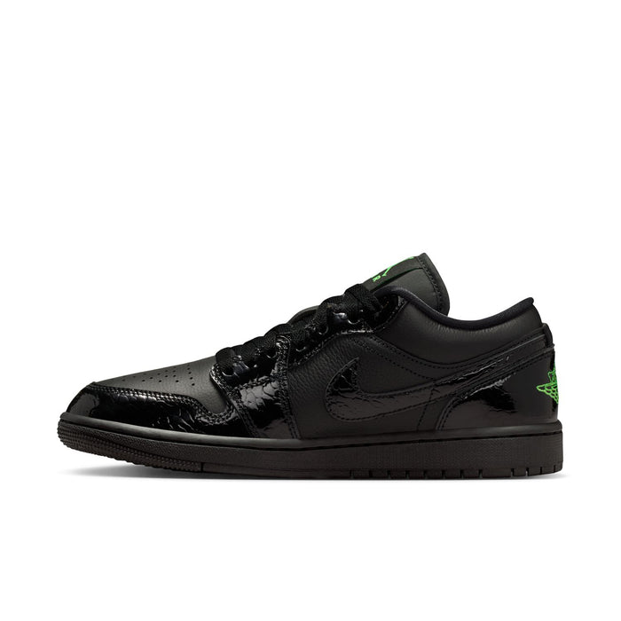 Black low-top sneaker side view with green accent logo and lace-up upper.