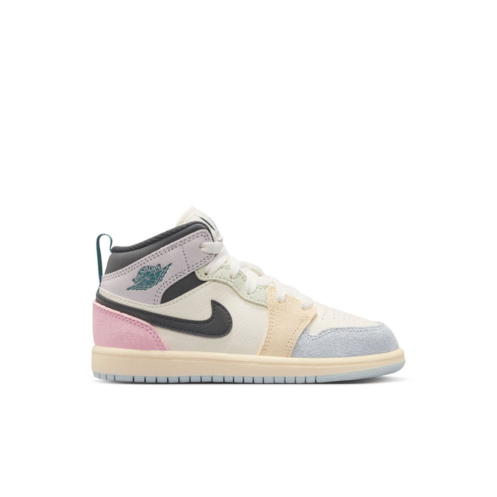 Kids Air Jordan 1 mid-top sneakers, white with pink, gray, and teal accents.
