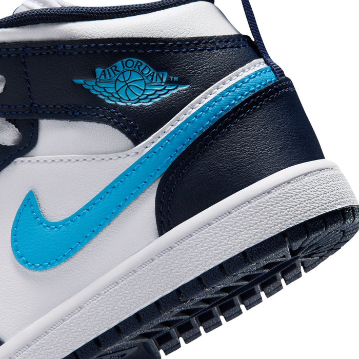 Kids sneaker close-up of navy collar tag, light blue stripe, and white outsole