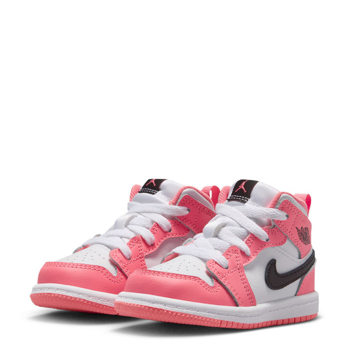 Pair of pink and white toddler mid-top sneakers with black swoosh and white lace-up design