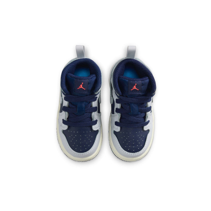 Toddler sneaker top view with navy laces, white uppers, and red Jumpman on tongue