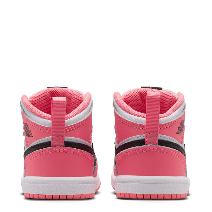 Back view of pink and white toddler mid-top sneakers with black collar trim and lace tabs