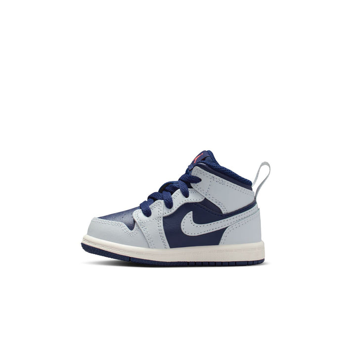 Toddler mid-top sneaker in navy and white with lace-up front and swoosh on side