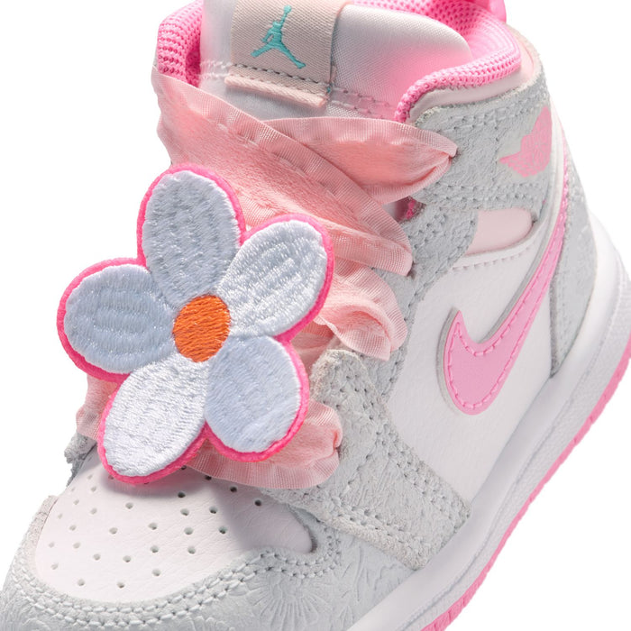 Close-up of toddler sneaker with pink flower applique, lace bow, and gray upper