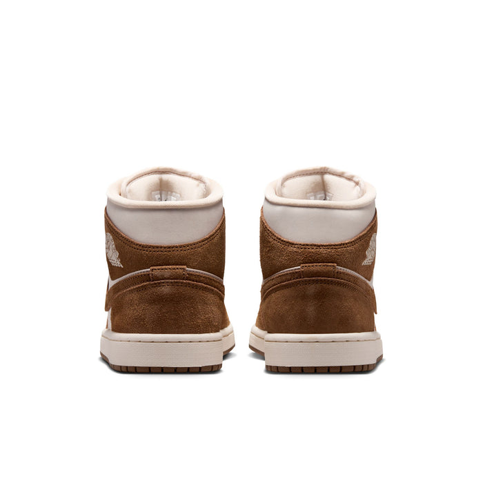 Women's mid-top sneakers shown from back with brown suede heels and white collars