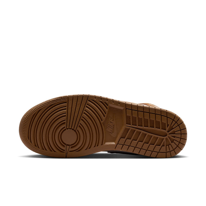 Brown rubber outsole with circular tread pattern on women's mid-top sneakers