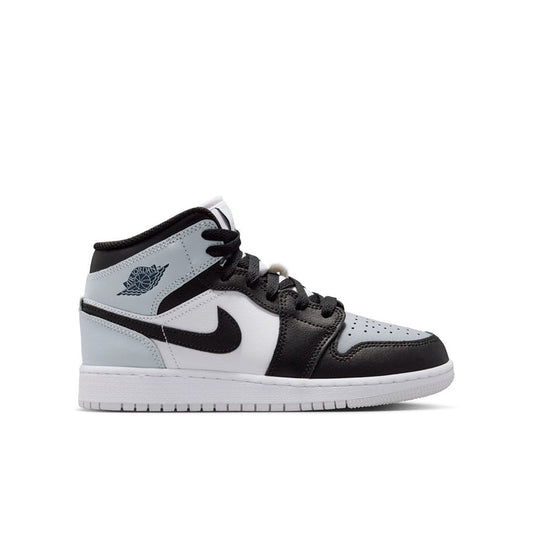 White and black mid-top youth sneakers with light blue accents and black laces