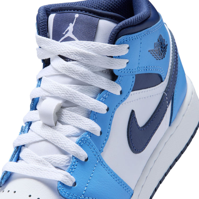 Close-up of youth mid-top sneaker upper: white laces, light blue overlays, navy swoosh
