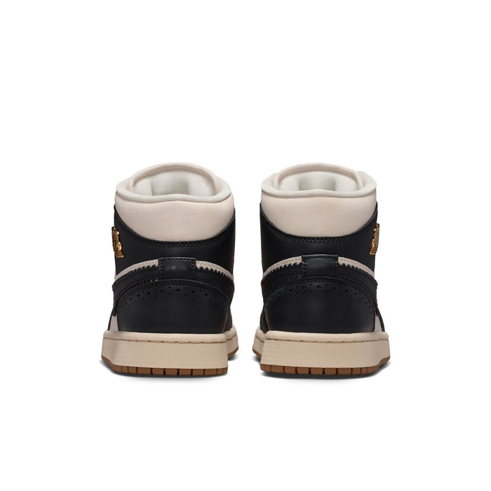 Back view of women’s mid-top sneakers with black heel panels and off-white lining