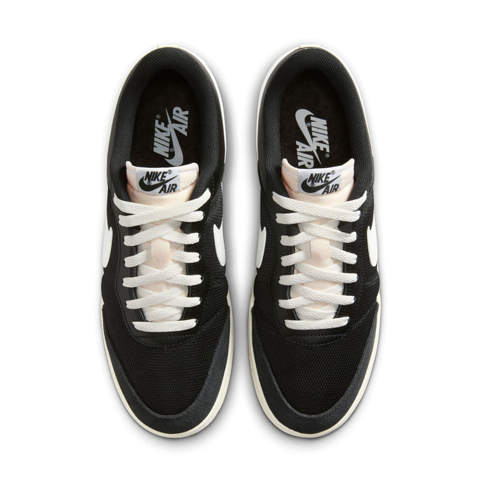 Men's black low-top sneakers with white laces and Nike Air branding, gum sole