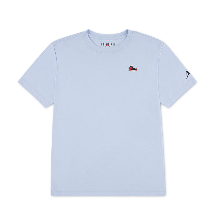 Youth light blue T-shirt with small Jordan sneaker patch on left chest