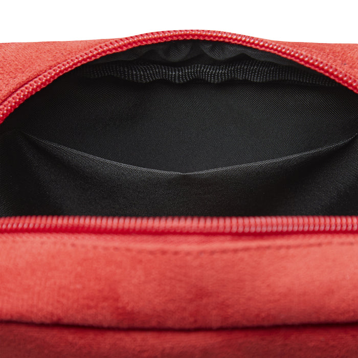 Open zip-top interior of red crossbody bag with black lining and fabric texture
