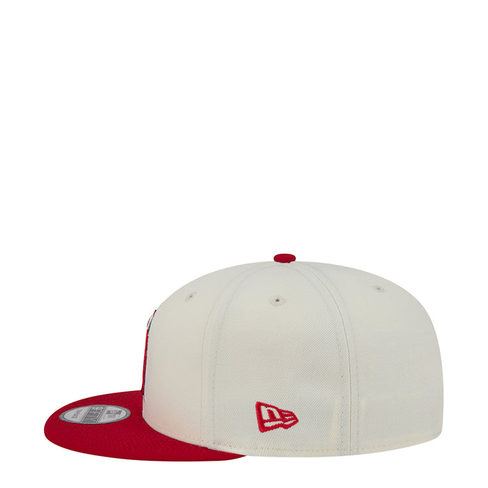 Two-tone baseball cap with white crown, red brim, small red A side logo
