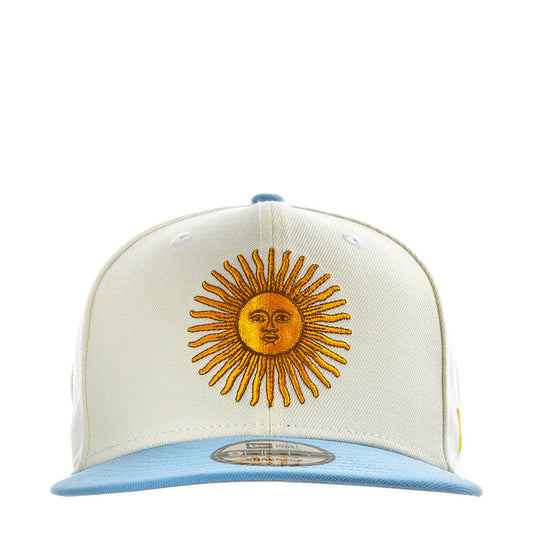 Cream baseball cap with embroidered sun face and light blue brim
