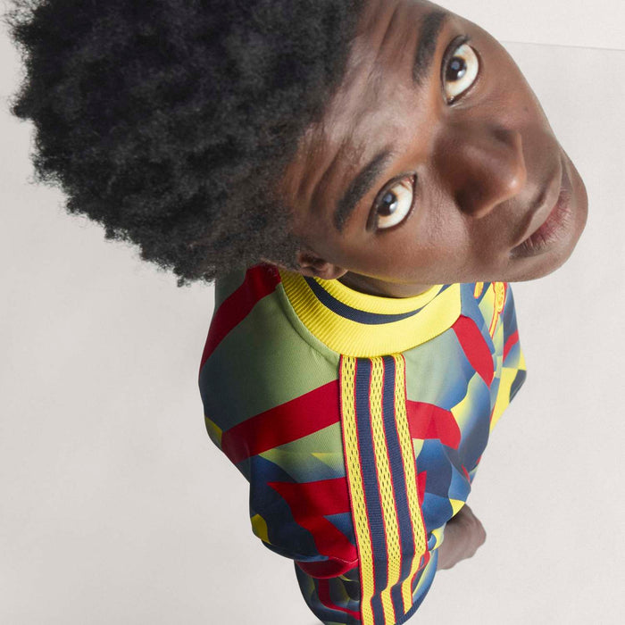 Men's multicolor jersey with yellow collar and red, blue, green geometric print