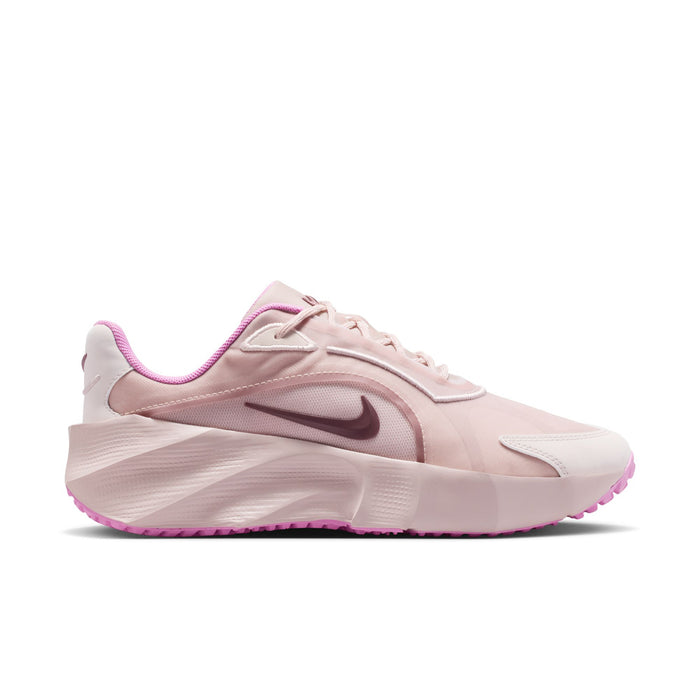 Light pink women’s running sneakers with purple accents and side Nike swoosh