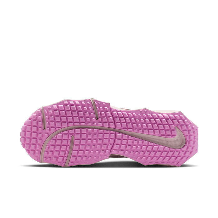 Purple rubber outsole with tread pattern and Nike swoosh for women’s running sneakers