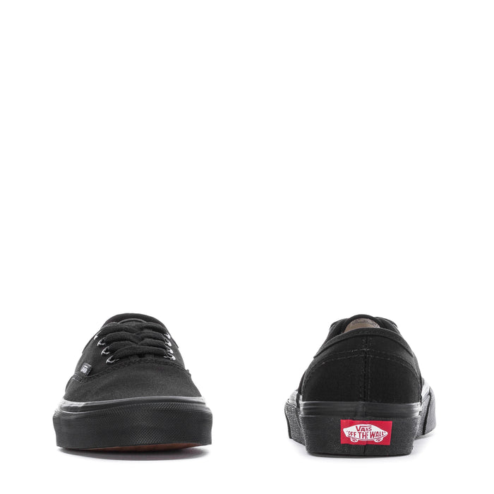 Black youth low-top sneakers back view with Vans heel label and rubber sole