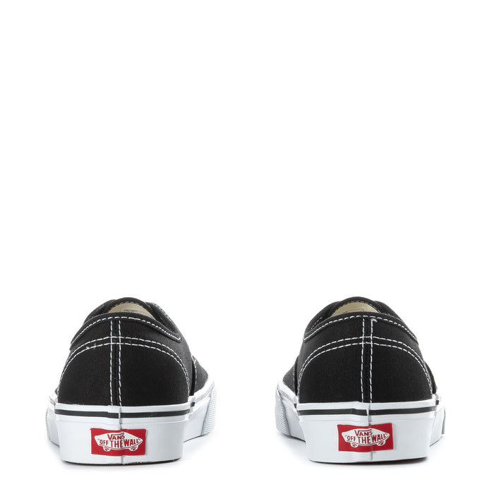 Youth black canvas sneakers, heel view with white Vans logo tag