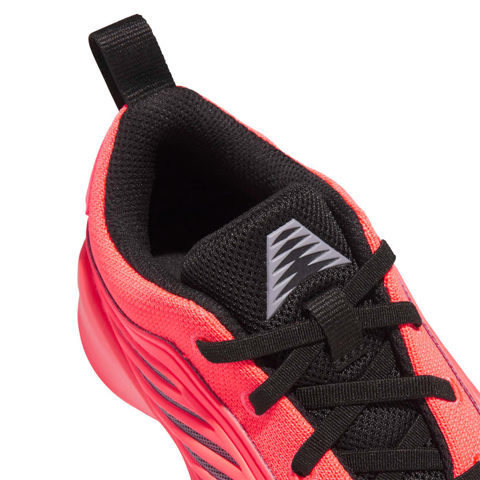 Kids sneaker upper close-up, orange fabric with black laces and gray logo on tongue.
