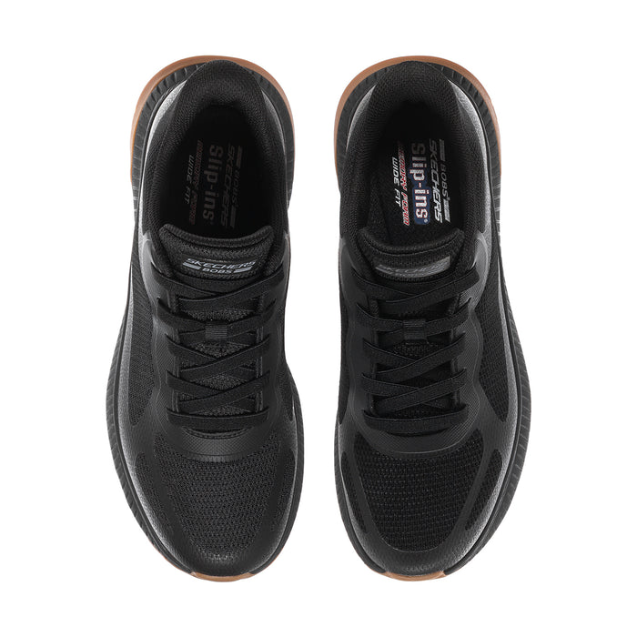 Pair of black slip-on sneakers showing cushioned tongue and laces