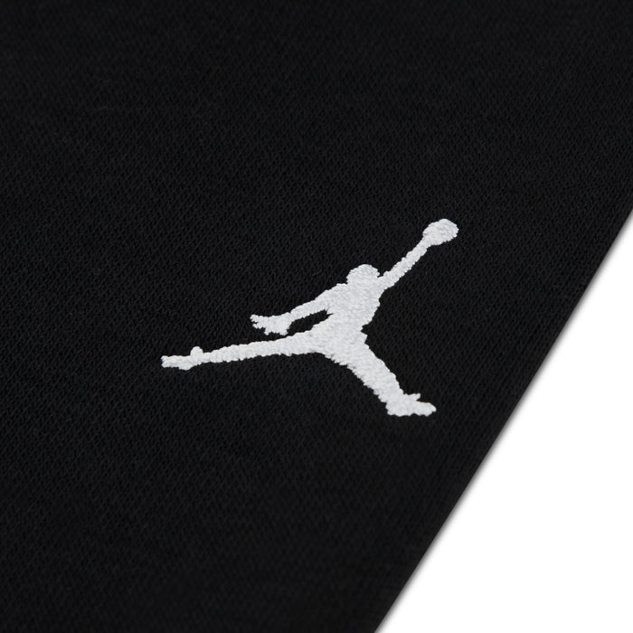 Black jogger leg with white Jordan Jumpman logo, knit fleece fabric