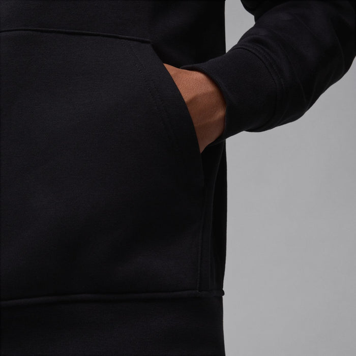 Black fleece pullover hoodie sleeve and kangaroo pocket detail