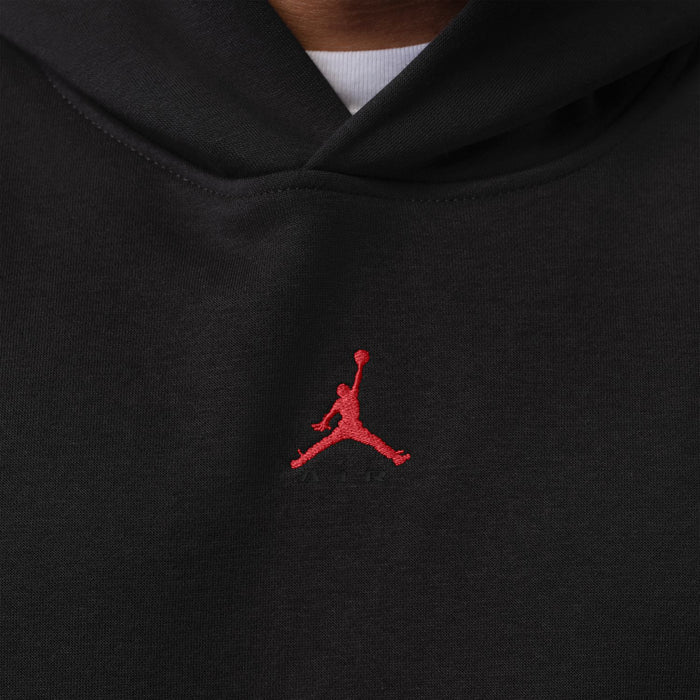 Men's black hoodie chest logo close-up featuring red Jumpman