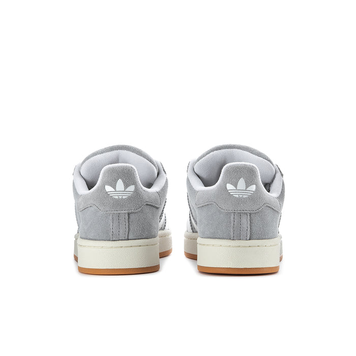 Men's grey low-top sneakers with heel tab and white logo stripes; gum outsole