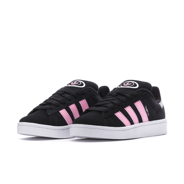 Black low-top sneakers with pink and white triple stripes and lace-up closure.