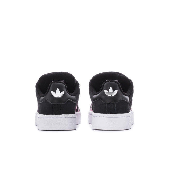 Back view of black low-top sneakers with white sole and pink stripe heel detail.