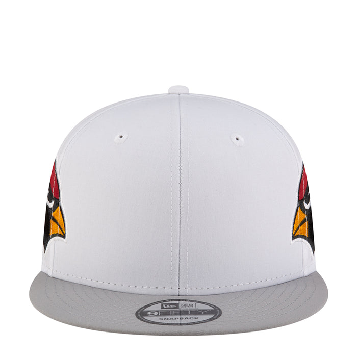 White snapback cap with gray brim and side logo accents in red and yellow