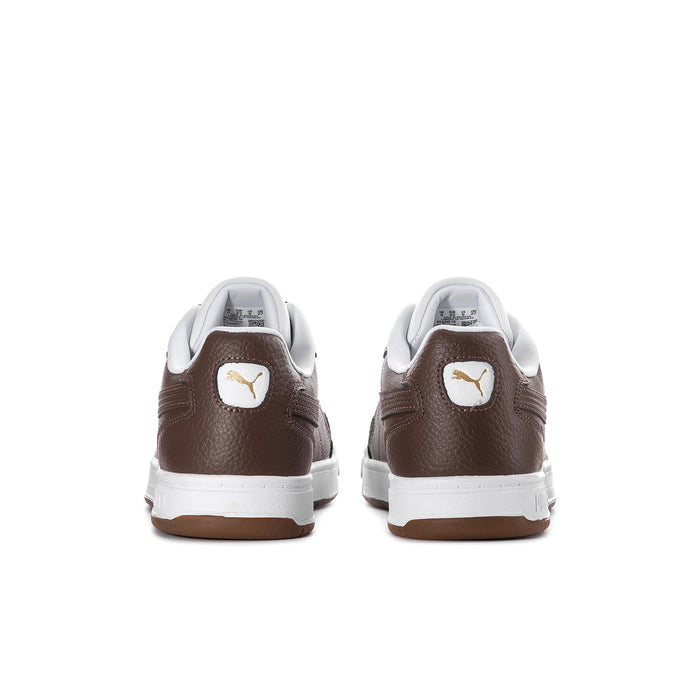 Brown and white sneakers from back with Puma emblem on the heel