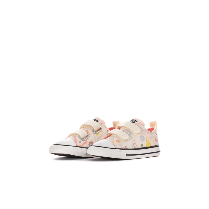 Kids' low-top canvas sneakers, side view; white upper with floral paisley accents and strap