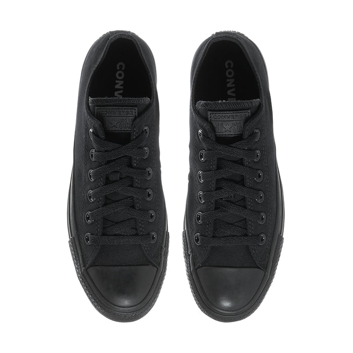 Black low-top lace-up canvas sneakers, interior view of tongue and laces