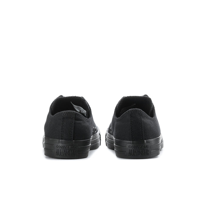 Black low-top lace-up canvas sneakers, rear view with heel branding and rubber sole