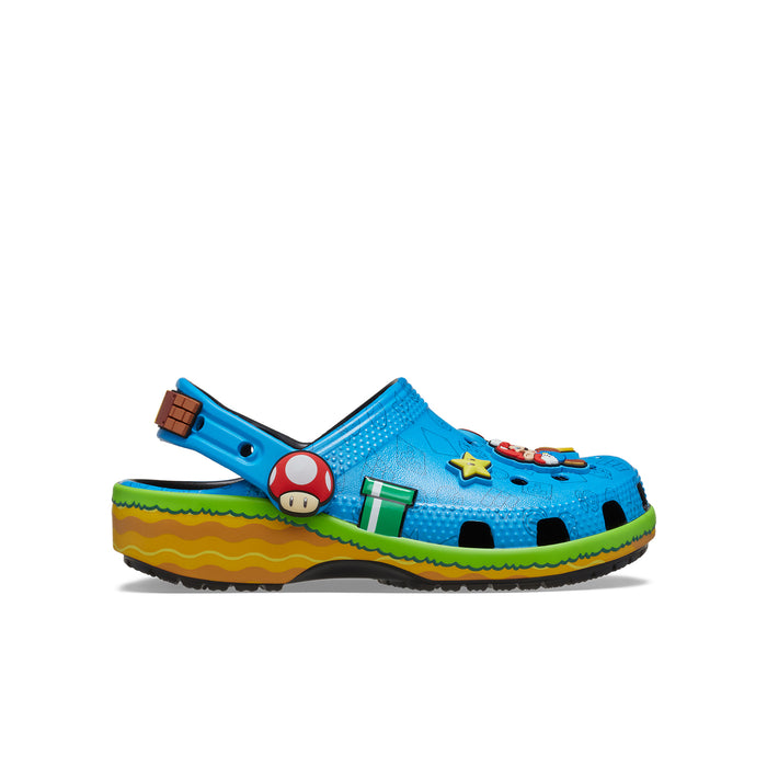 Kids blue clog with character graphics, green accents, and yellow wave sole