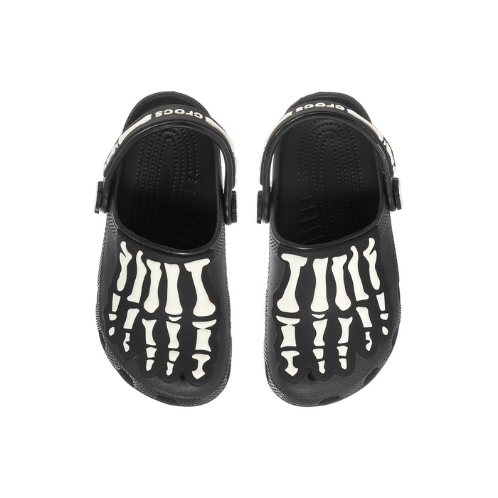 Kids' black clogs with white skeleton-bone graphics on front, adjustable back strap