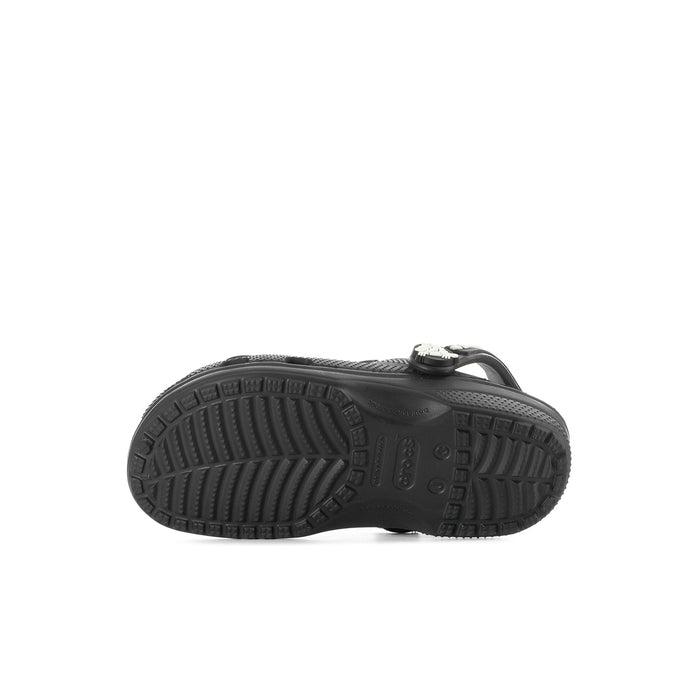 Kids' black clog outsole view with rugged tread and crocs logo on heel